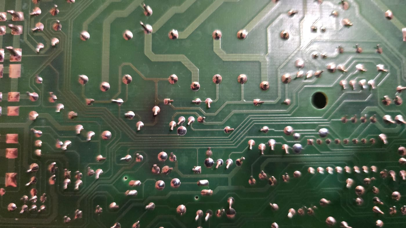 Heat-scorched solder joints on a failed garage door opener circuit board