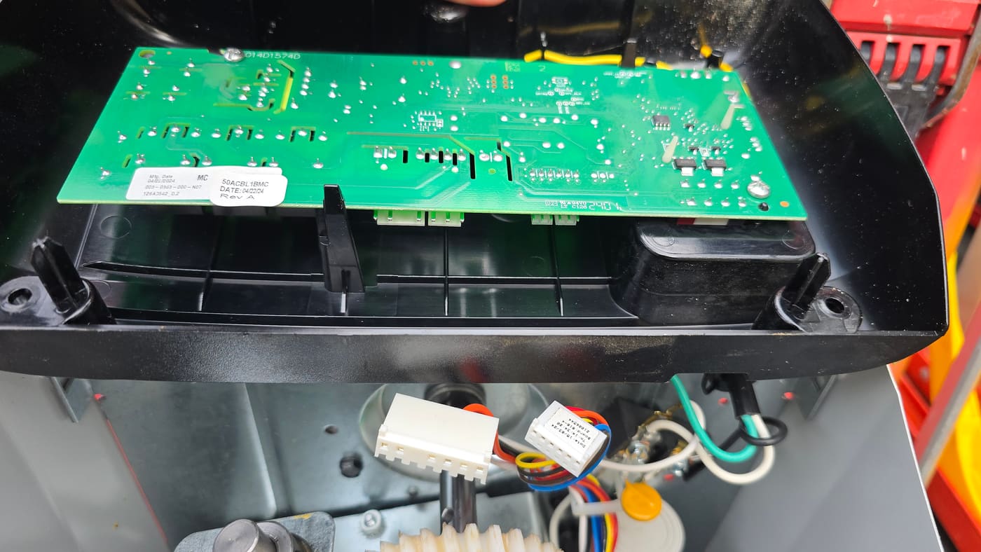 Technician diagnosing a garage door opener logic board in Tyler, Texas