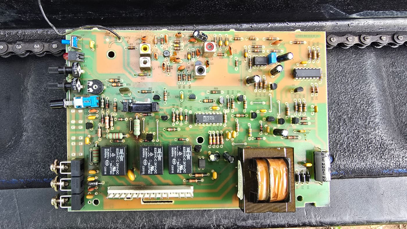 Garage door opener logic board showing relays, radio receiver, and power components